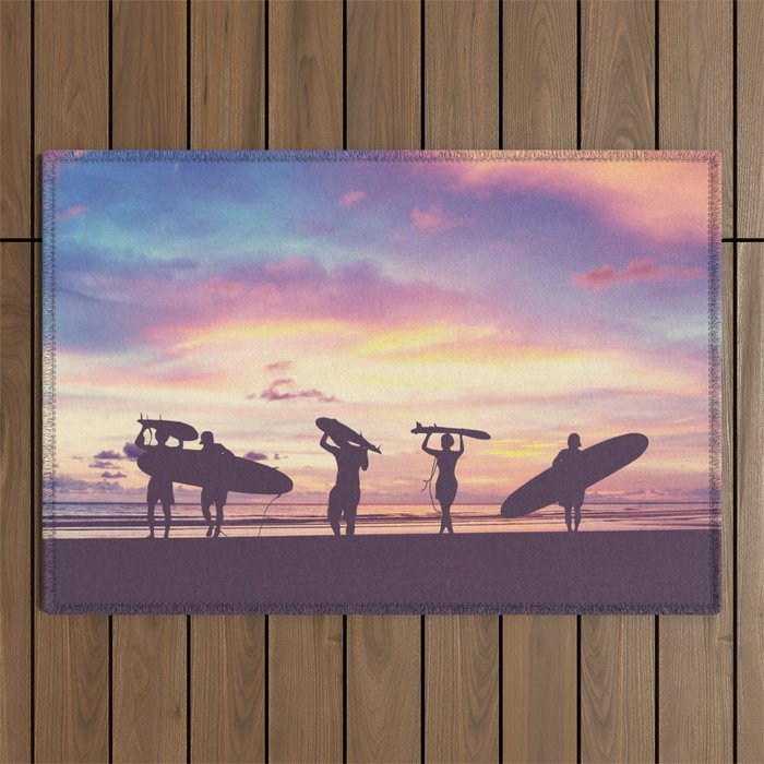 Silhouette Of surfer people carrying their surfboard on sunset beach, vintage filter effect with soft style Outdoor Rug