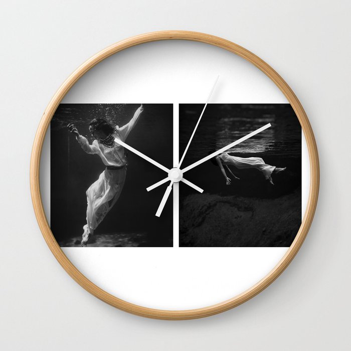 Underwater view of a women, wearing a long gown, floating in water collage fashion and glamour photography / photographs by Toni Frissell Wall Clock