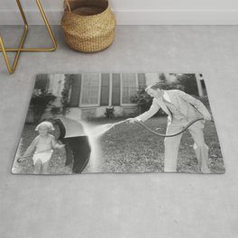 Always look on the bright side of life; little girl thwarting father with hose using umbrella humorous funny black and white photograph - photography - photograph Area & Throw Rug