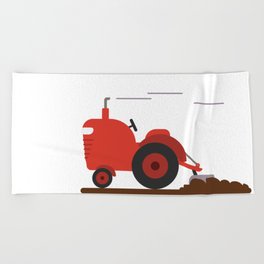 A vintage tractor plowing the land Beach Towel