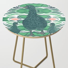 Beautiful mother duck and ducklings walking on a green patterned background Side Table