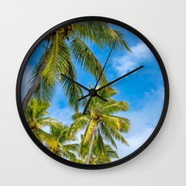 Coconut Palm Trees against the blue sky at Isle of Pines in New Caledonia. Wall Clock