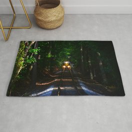 Train through the forest tunnel Rug