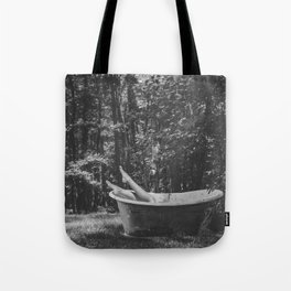Back to nature; female with legs in the air out of vintage bear claw bathtub amid the wilderness and summer woods black and white photograph - photography - photographs Tote Bag