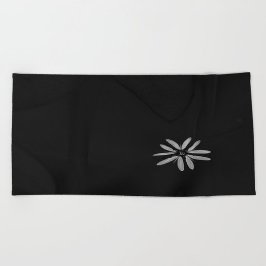 One Tiny White Flower on Black Background Beach Towel