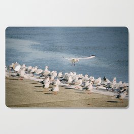 Seagulls sunbathing | No place to land in sea birds gathering  Cutting Board