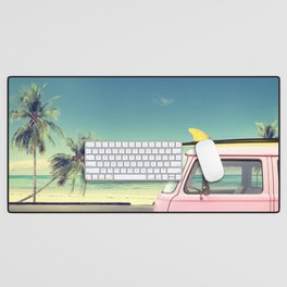 Vintage car in the beach with a surfboard on the roof Desk Mat