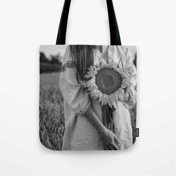 Sunflower; still life portrait young woman holding sunflower in harvest field floral blossom black and white photograph - photography - photographs Tote Bag