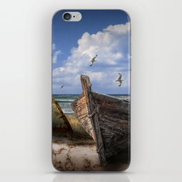 Stranded Boats on a Beach under a Cloudy Blue Sky iPhone Skin