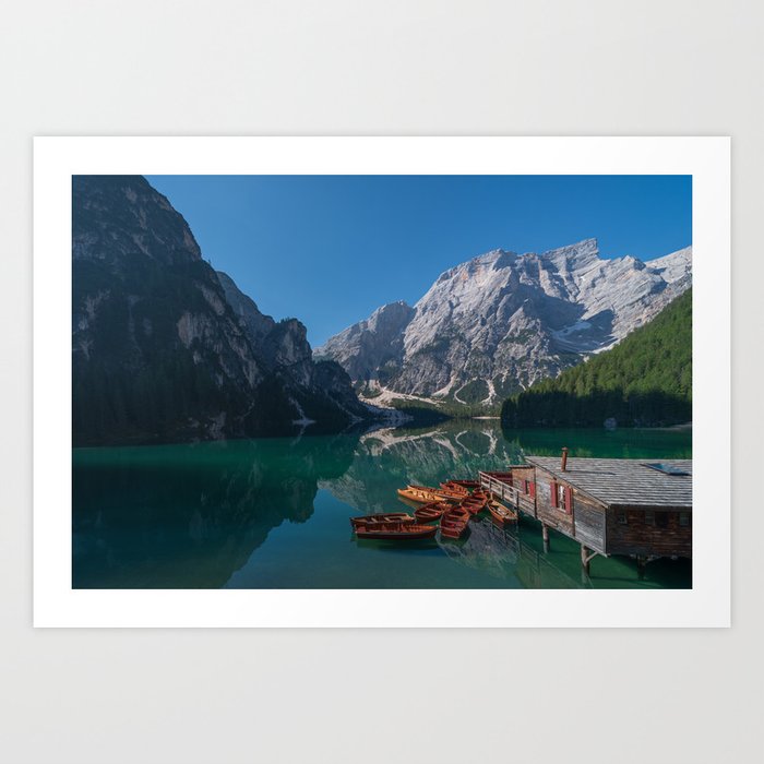 The Seekofel mountains and wooden boats reflected in the waters of Lake Braies Art Print
