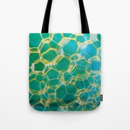 Soap suds extreme closeup creating honeycomb pattern on blurred background Tote Bag