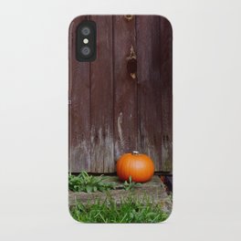 Orange pumpkin by wooden door iPhone Case