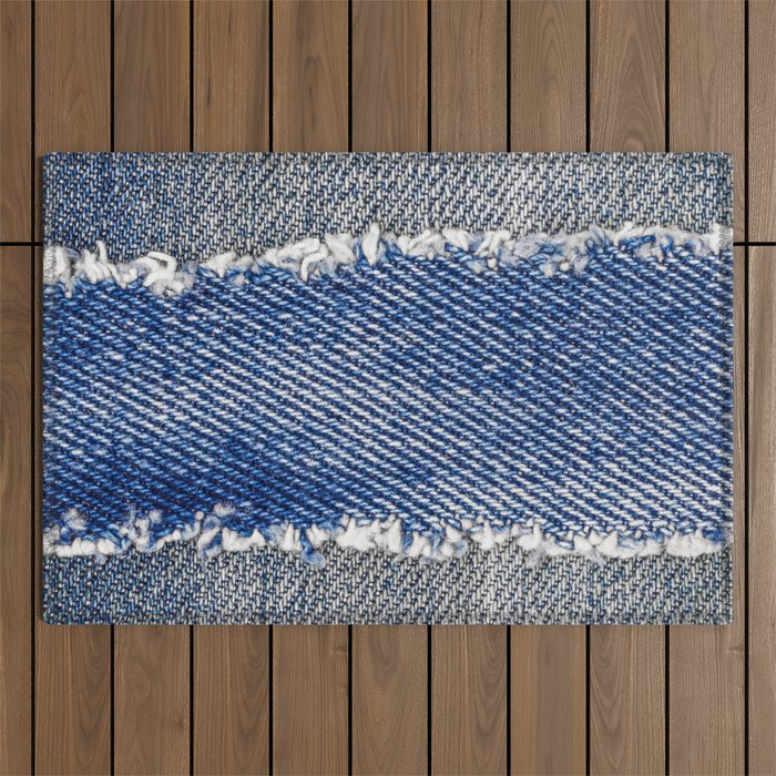 Denim frame. Ripped denim fabric with fringe edge on bleached denim background, text place, copy space. Worn Jeans Casual Double Color patch. Classic blue denim pattern texture  Outdoor Rug