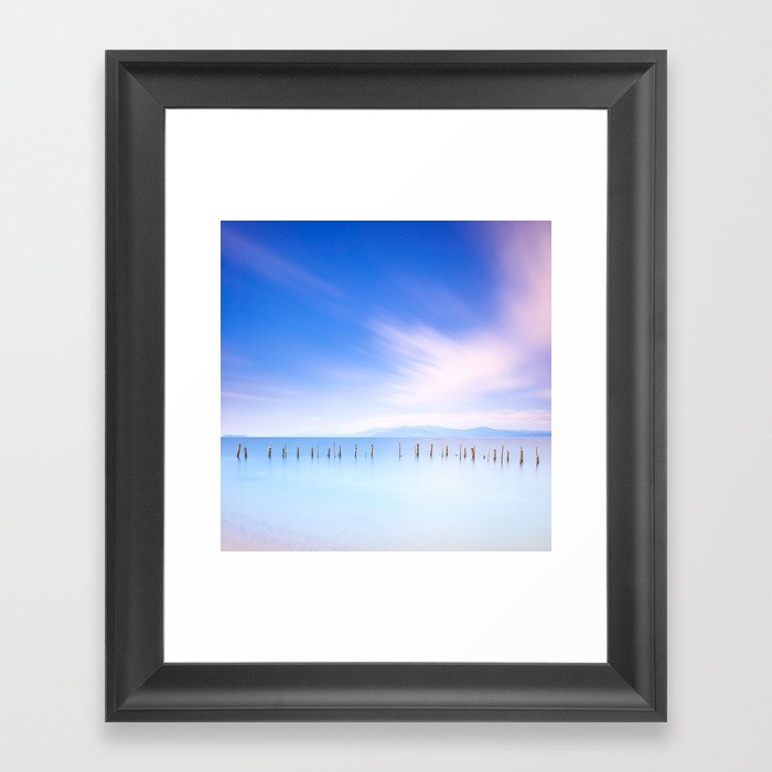 Poles and soft water landscape. Long exposure. Framed Art Print