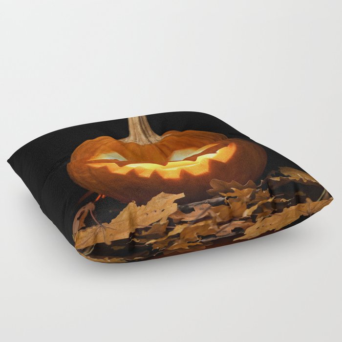 Carved Pumpkin for Halloween and Autumn Leaves on Black Background Floor Pillow