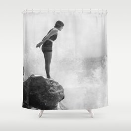 Female swimmer on rock above crashing surf Shower Curtain