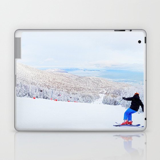 Skier at a ski resort with snowy mountain and lake Laptop & iPad Skin