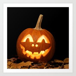 Carved Pumpkin for Halloween and Autumn Leaves on Black Background Art Print