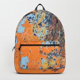 Orange metal background with cracked, peeling paint with stains of blue paint and rust spots. Backpack