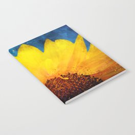 Partial sunflower on blue background Notebook