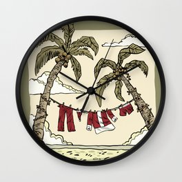 Santa Claus' costume hanging on a clothesline at the beach from two palm trees. Wall Clock