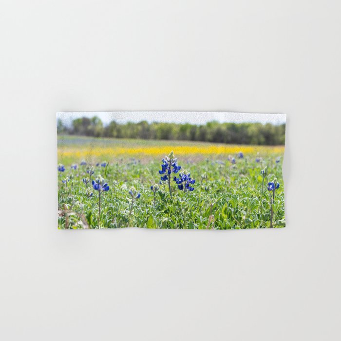 Closeup of Bluebonnet blooms with yellow flowers in background Hand & Bath Towel