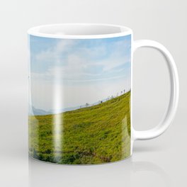 Wind turbine on the beautiful blue sky and on the tea field Coffee Mug