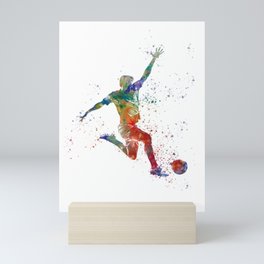 Soccer player kicking in watercolor Mini Art Print
