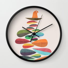 Bird nesting on top of pebbles hill Wall Clock