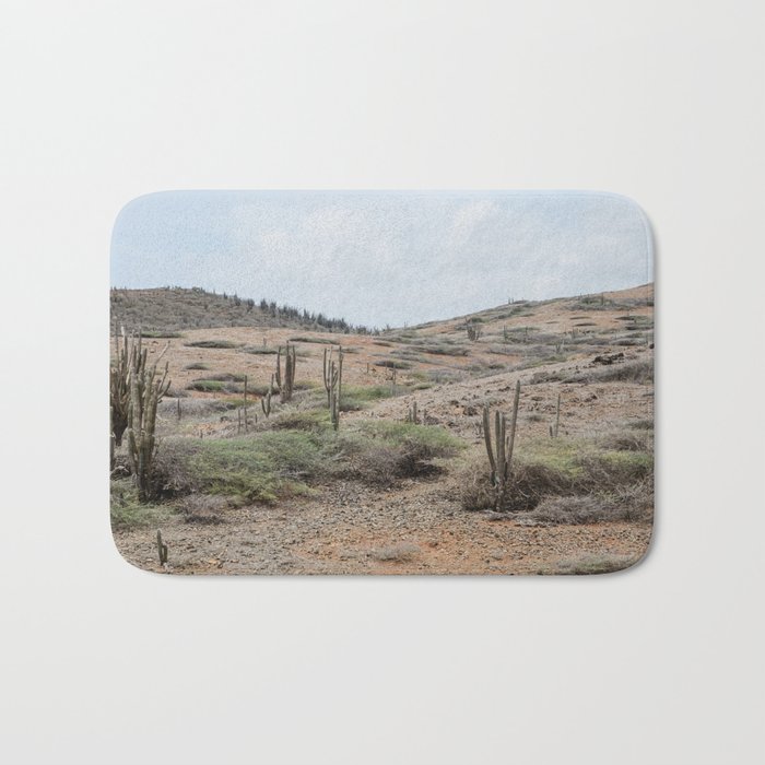 The dry rocky desert of Aruba with cacti and warm earthy colors Bath Mat