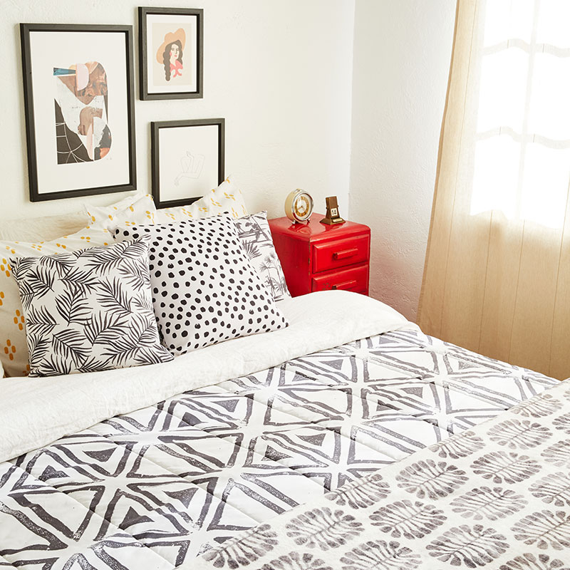 bed with white and brown patterned comforter