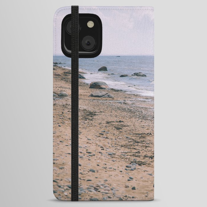 Girl in black running near the Baltic sea Coast, shore, beach, waves and grey sky on a stormy day iPhone Wallet Case