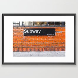 subway sign on a brick wall Framed Art Print