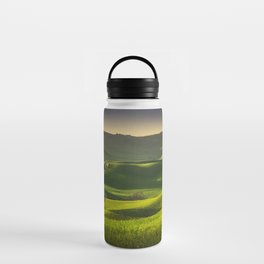 Springtime in Tuscany, rolling hills, wheat and tree at sunset. Water Bottle