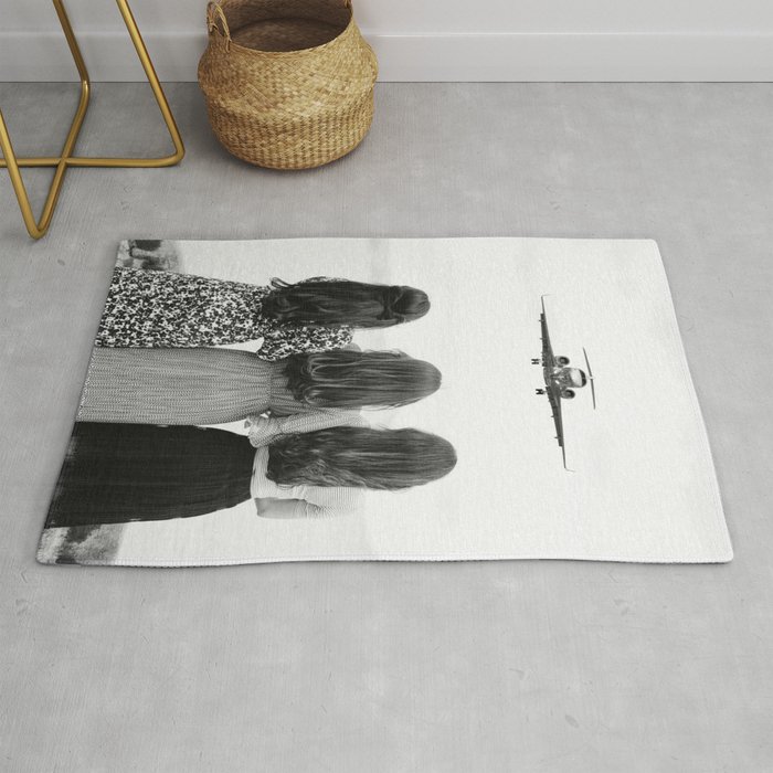 Sisters stand united II; airplane coming in for a landing head on at three women sisterhood girl power black and white photograph - photography - photographs Rug