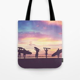 Silhouette Of surfer people carrying their surfboard on sunset beach, vintage filter effect with soft style Tote Bag