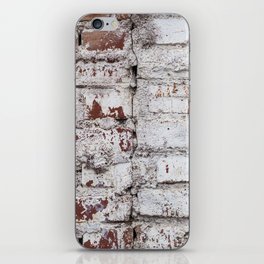Old painted brick wall with peeling white paint iPhone Skin