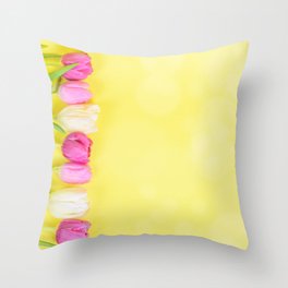 Row of multicolored tulips for border or frame over yellow blurred background Throw Pillow