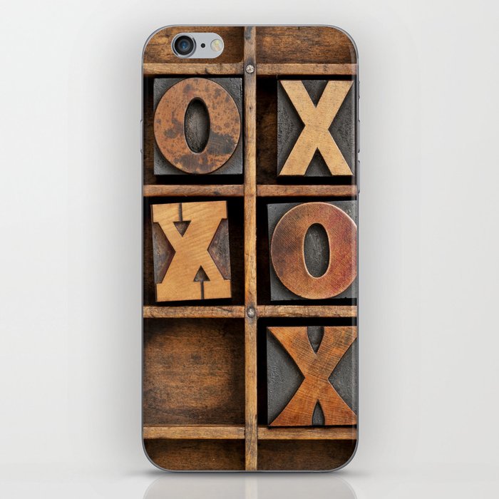 tic-tac-toe or noughts and crosses game - vintage letterpress ing block X and O in wooden grunge typesetter box with dividers iPhone Skin
