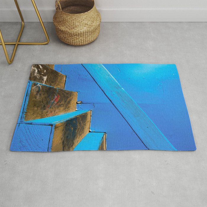 blue and brown old wood stairs with blue wall background Rug