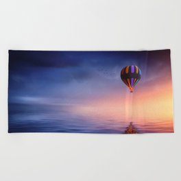 Baloon at sunset on the ocean Beach Towel