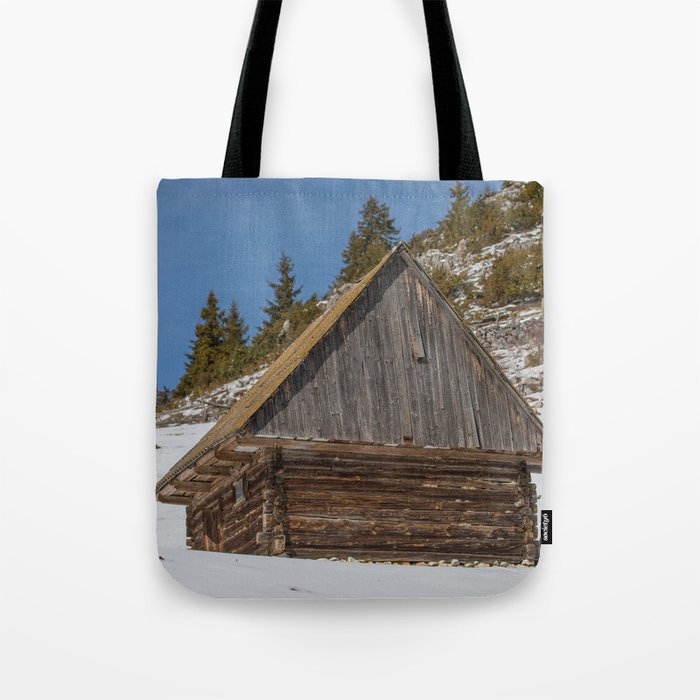 Old mountain house with Carpathian mountains in the background Tote Bag