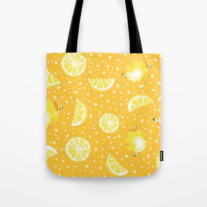 Lemons squeezed on a orange background Tote Bag