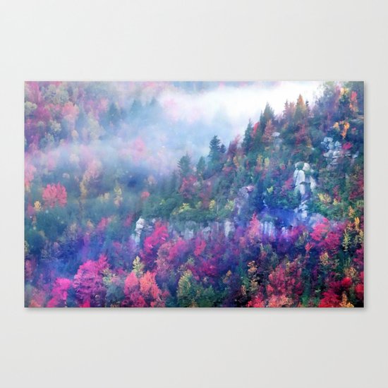Fog over a colorful fall mountain forest Canvas Print