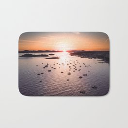 Dramatic sunset on the sea coast with boats in the sea Bath Mat
