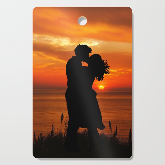 Sunset Kissing on the beach Cutting Board