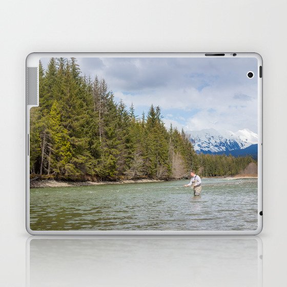 A fisherman spey casting on a mountain river in spring, in British Columbia, Canada Laptop & iPad Skin