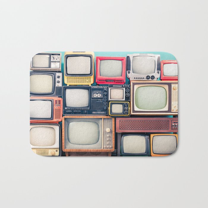 Retro TV receivers set from circa 60s, 70s and 80s of XX century, old wooden television stand with amplifier front mint blue wall background. Broadcasting, news concept. Vintage style filtered photo Bath Mat