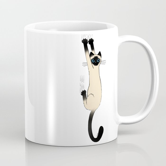 Siamese Cat Hanging On Coffee Mug