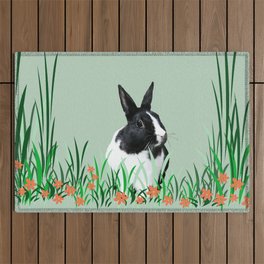Black and white Rabbit sitting in Grass with flowers Outdoor Rug
